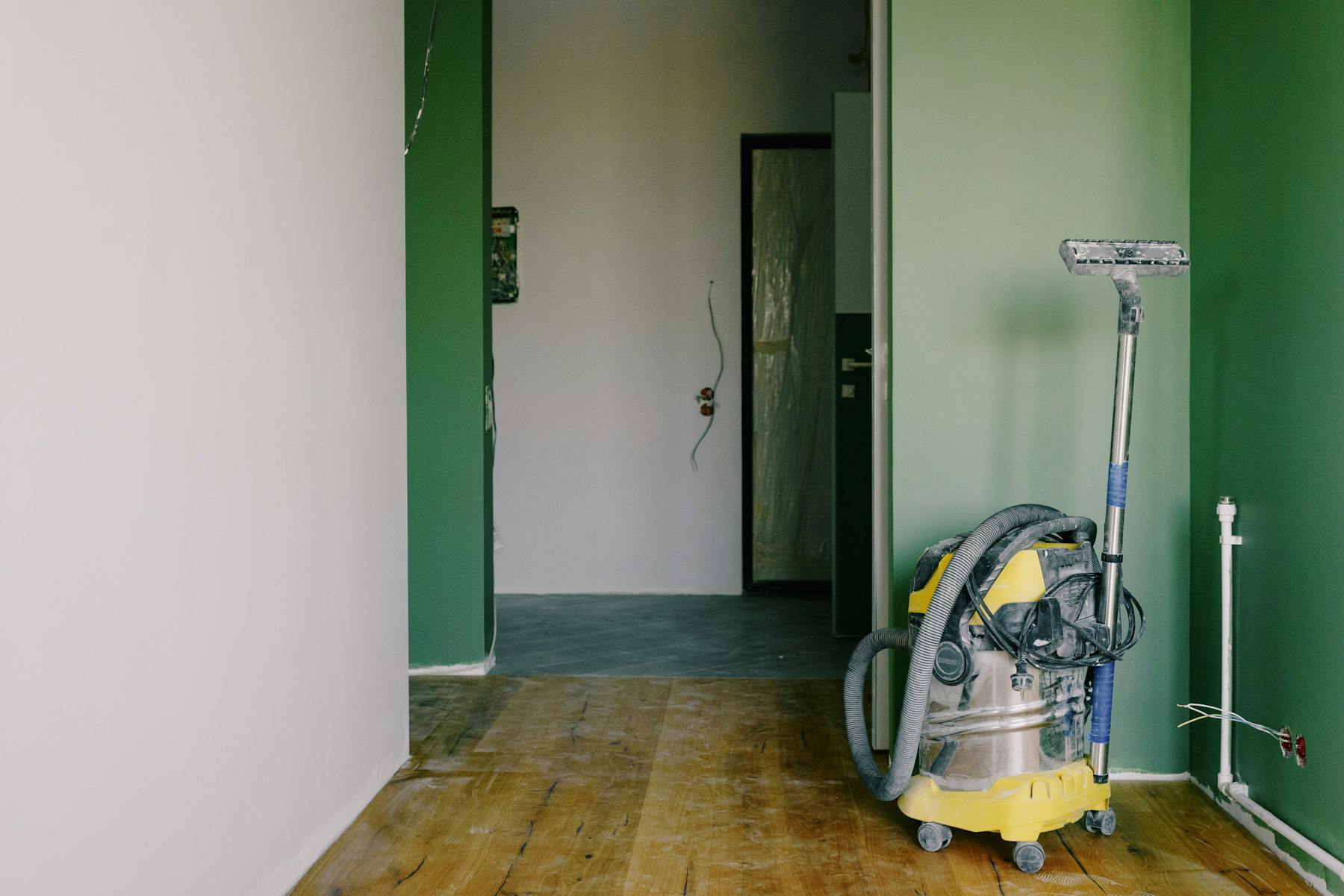 Water cleanup equipment positioned on a damaged interior floor